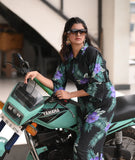 Yezwe modest wear jumpsuit in floral design, styled with sunglasses and seated on a motorcycle