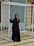 Yezwe modest wear maxi dress in black, featuring a belt and flowing silhouette for elegant style