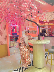 Yezwe Modest Wear Maxi Dress in floral design set against a vibrant cafe backdrop