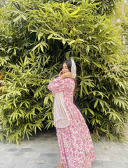 Yezwe modest wear maxi dress in pink floral print modeled outdoors against green bamboo backdrop
