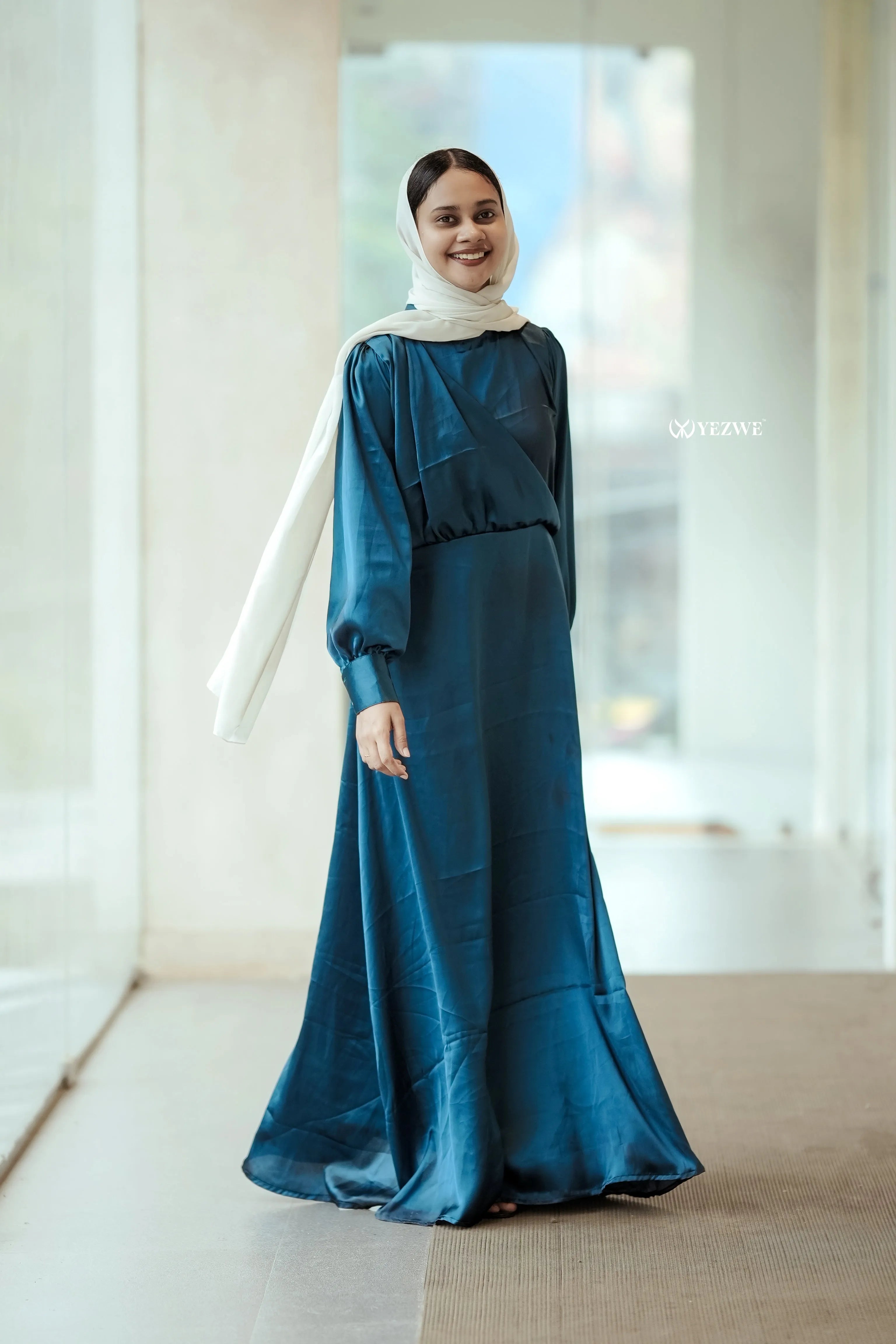 Elegant Yezwe modest wear maxi dress in teal with long sleeves and a flowing silhouette