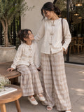 Mom and daughter matching co ord set featuring stylish beige tops and checkered wide-leg pants