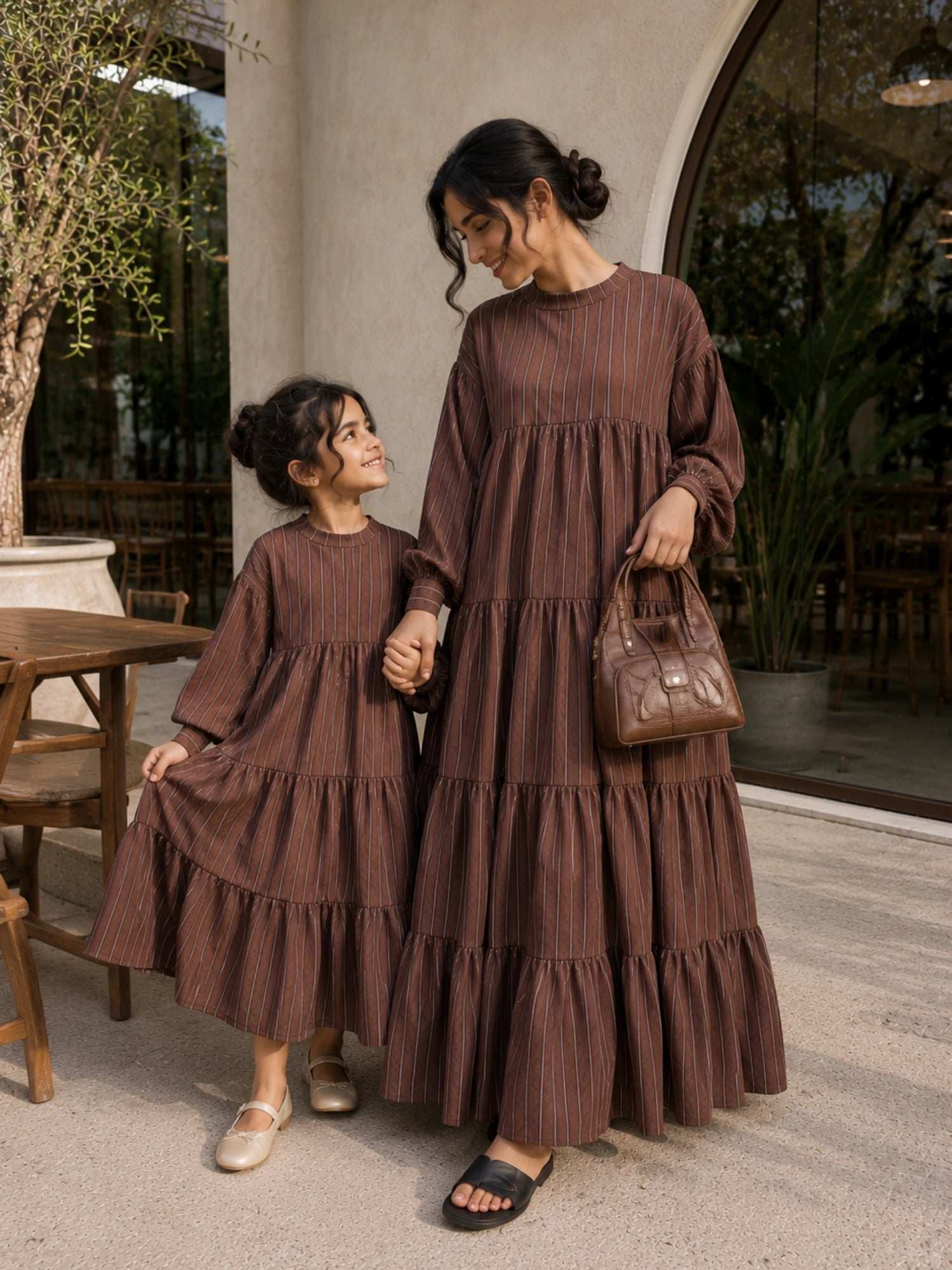 Mom and daughter matching tiered maxi dress set in brown stripes, perfect for stylish outings together