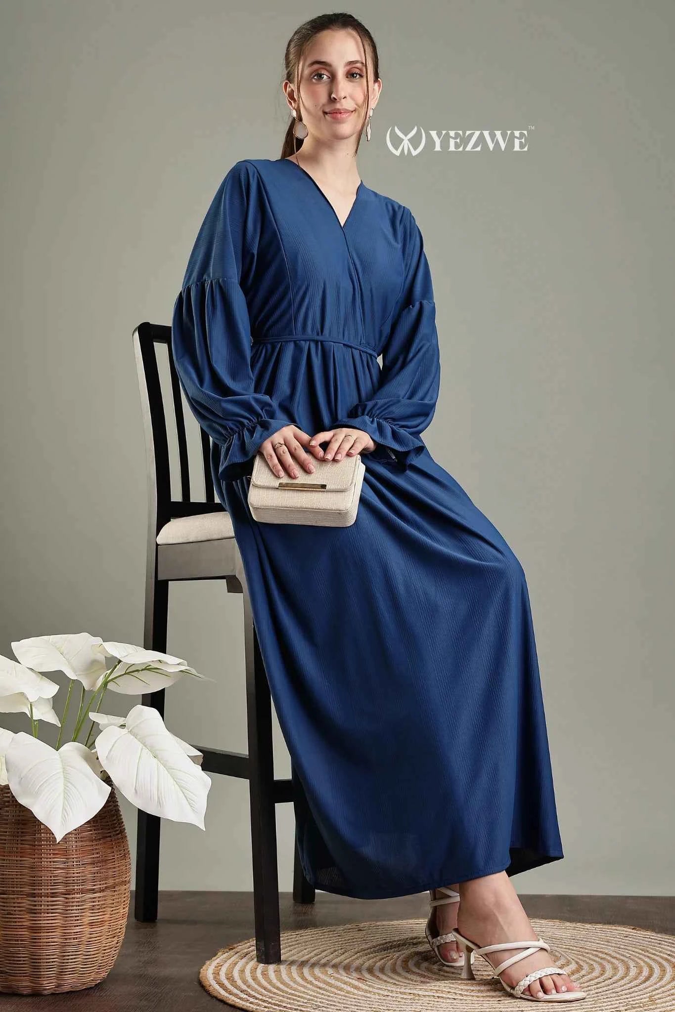 YEZWE navy blue modest maxi dress featuring a v-neck and puff sleeves, styled with a clutch