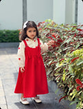 Young girl wearing red pinafore for junior girls by YEZWE outdoors near plants