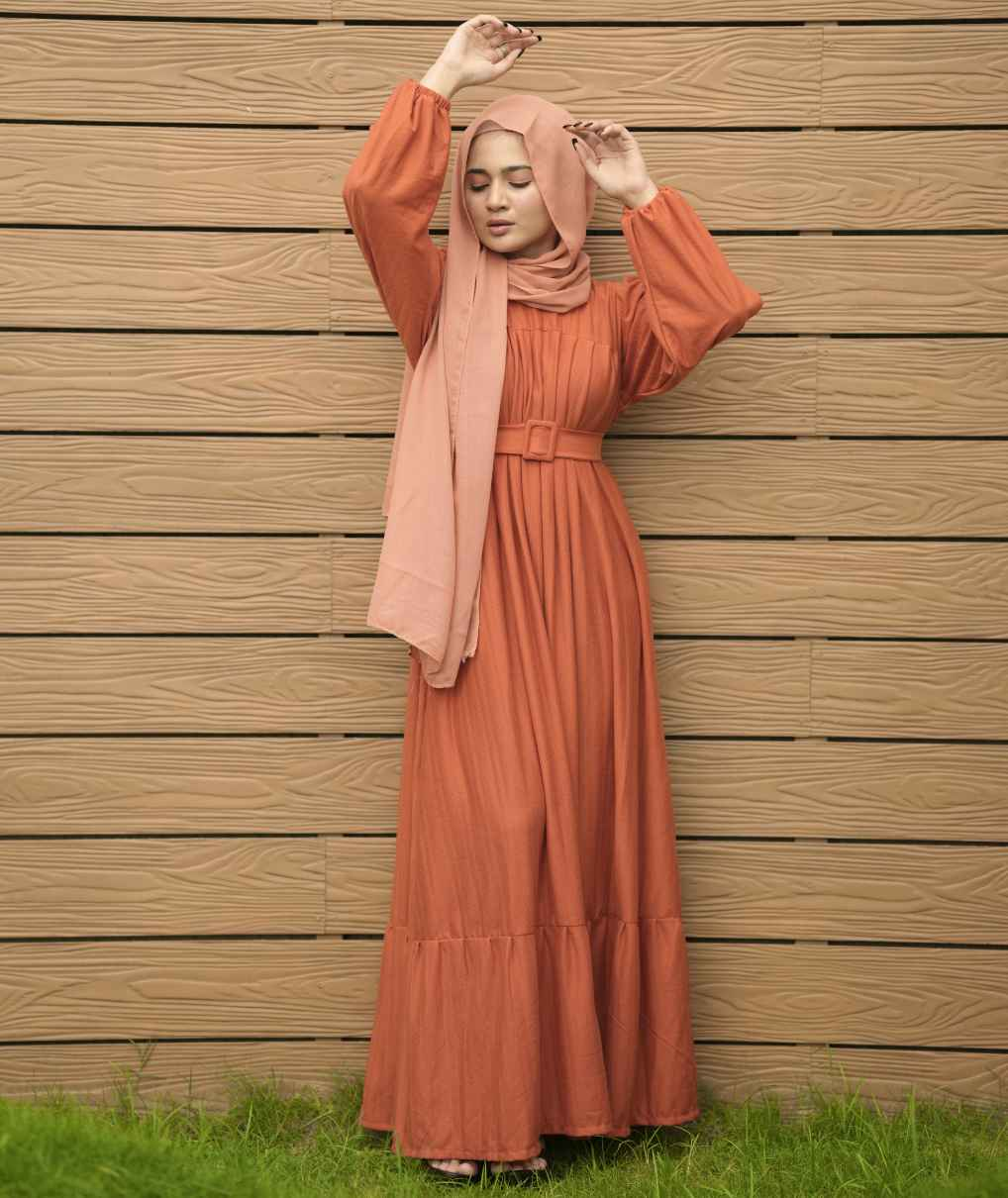 Yezwe textured rib maxi dress with belt in rust color, featuring long sleeves and a flowy silhouette