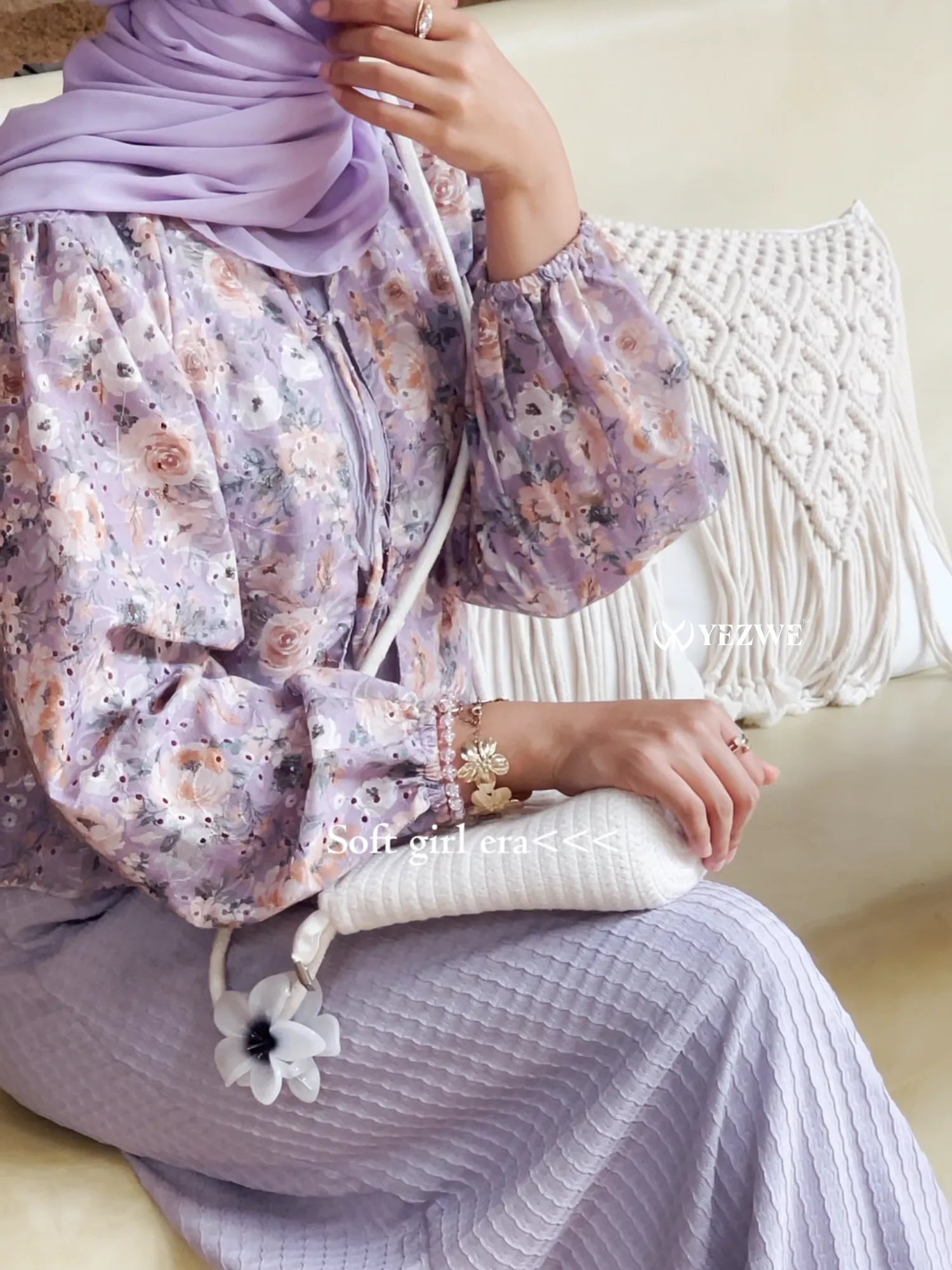Modest lavender maxi dress paired with floral blouse and a stylish white handbag