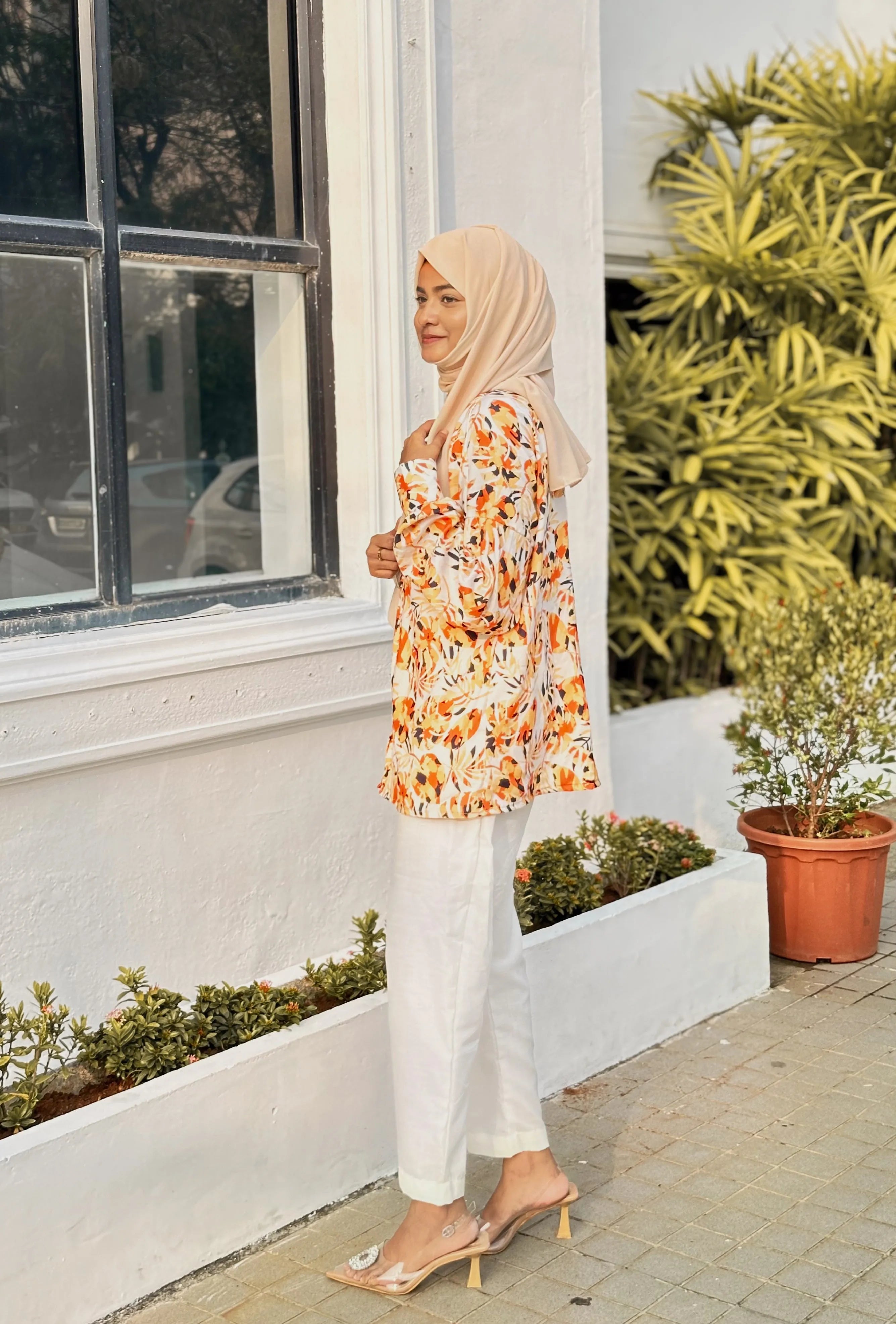 Stylish model in yellow print top and white pants, perfect for casual outings or summer wear