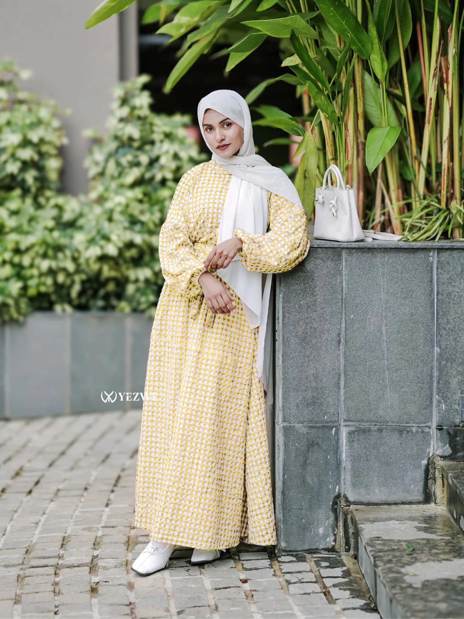 Yezwe yellow textured maxi dress with long sleeves and a relaxed fit, paired with a white hijab and stylish accessories