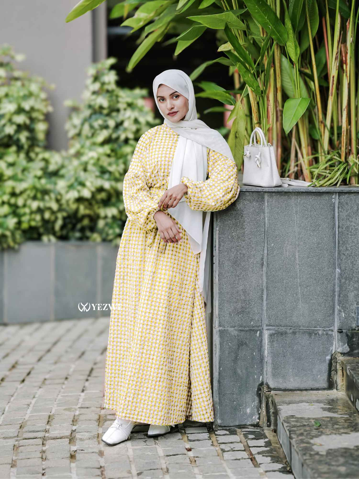 Yezwe yellow textured maxi dress with long sleeves and a relaxed fit, paired with a white hijab and stylish accessories