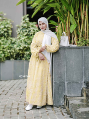 Yezwe yellow textured maxi dress with long sleeves and a relaxed fit, paired with a white hijab and stylish accessories