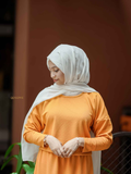 Modest orange co-ord set featuring a top and skirt, paired with a stylish hijab