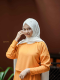Modest orange co-ord set featuring a stylish top and matching skirt, perfect for casual occasions
