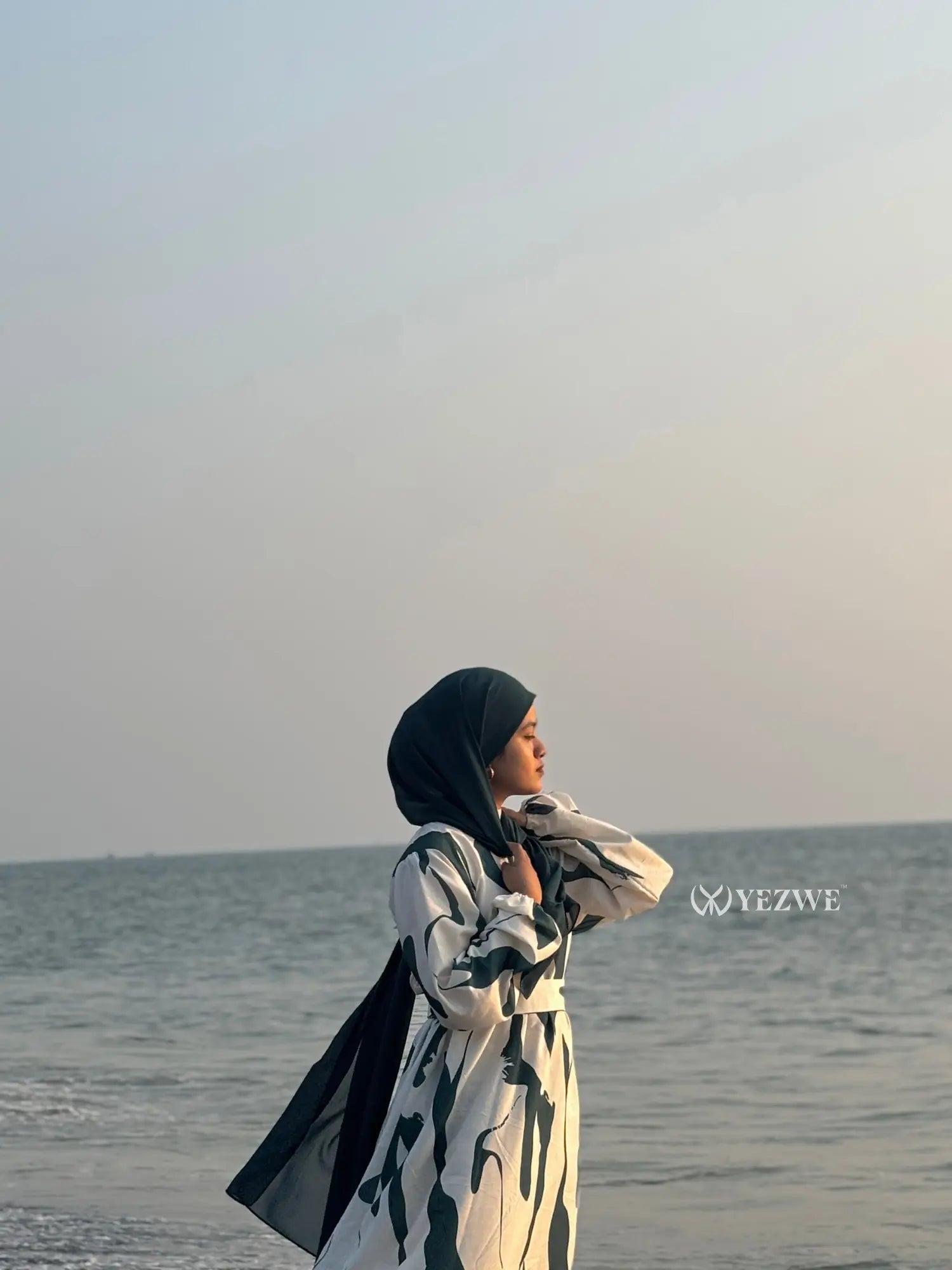 Yezwe modest ocean wave maxi dress worn by a woman at the beach against a tranquil sea backdrop