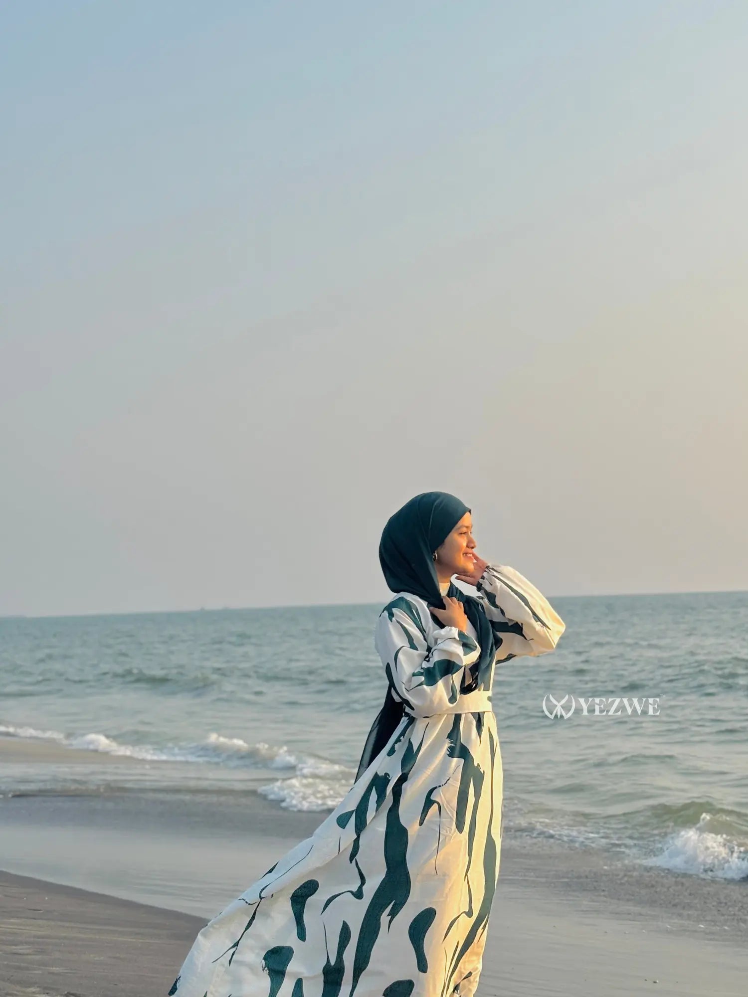 Yezwe modest ocean wave maxi dress in elegant design on the beach with a model enjoying the sea breeze