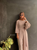 Woman wearing YEZWE Nomade Cey Jumpsuit with a hijab and sunglasses standing