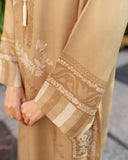 Close-up of beige modest dress sleeve with embroidery and border detailing