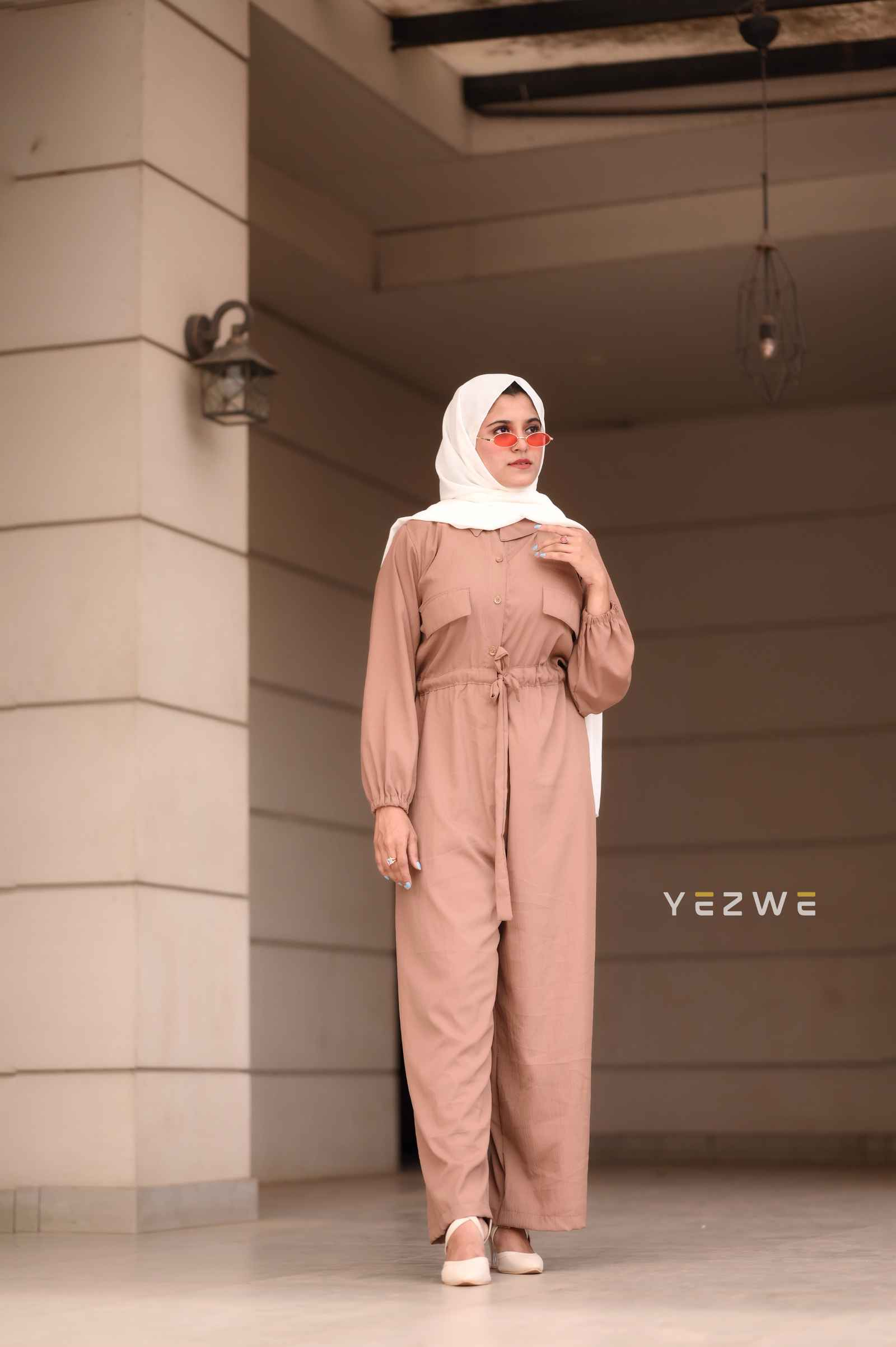 Yezwe belted front open jumpsuit in beige with long sleeves and a stylish design for casual occasions