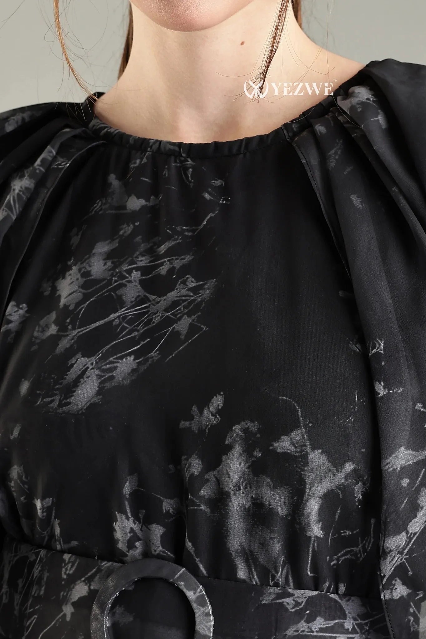 Close-up of YEZWE black floral print belted modest maxi dress showcasing elegant fabric and design details