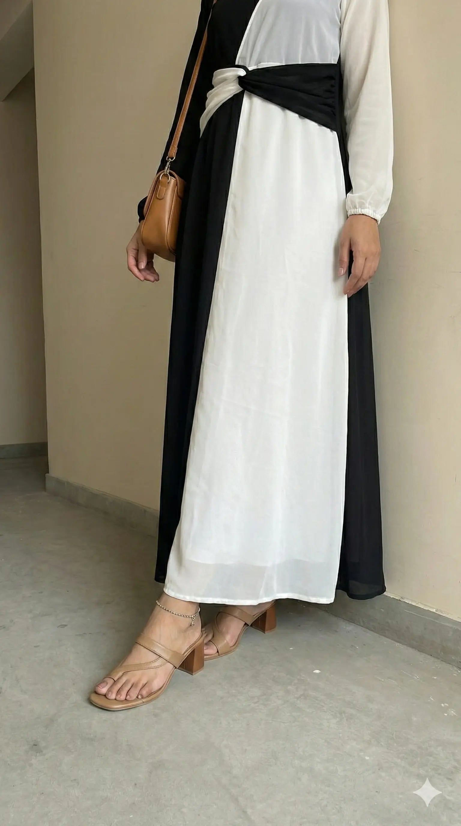 close up view of black and white dual tone modest maxi dress showing skirt detail and lower portion