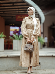 Yezwe brown textured maxi dress with button details and long sleeves, styled with a handbag