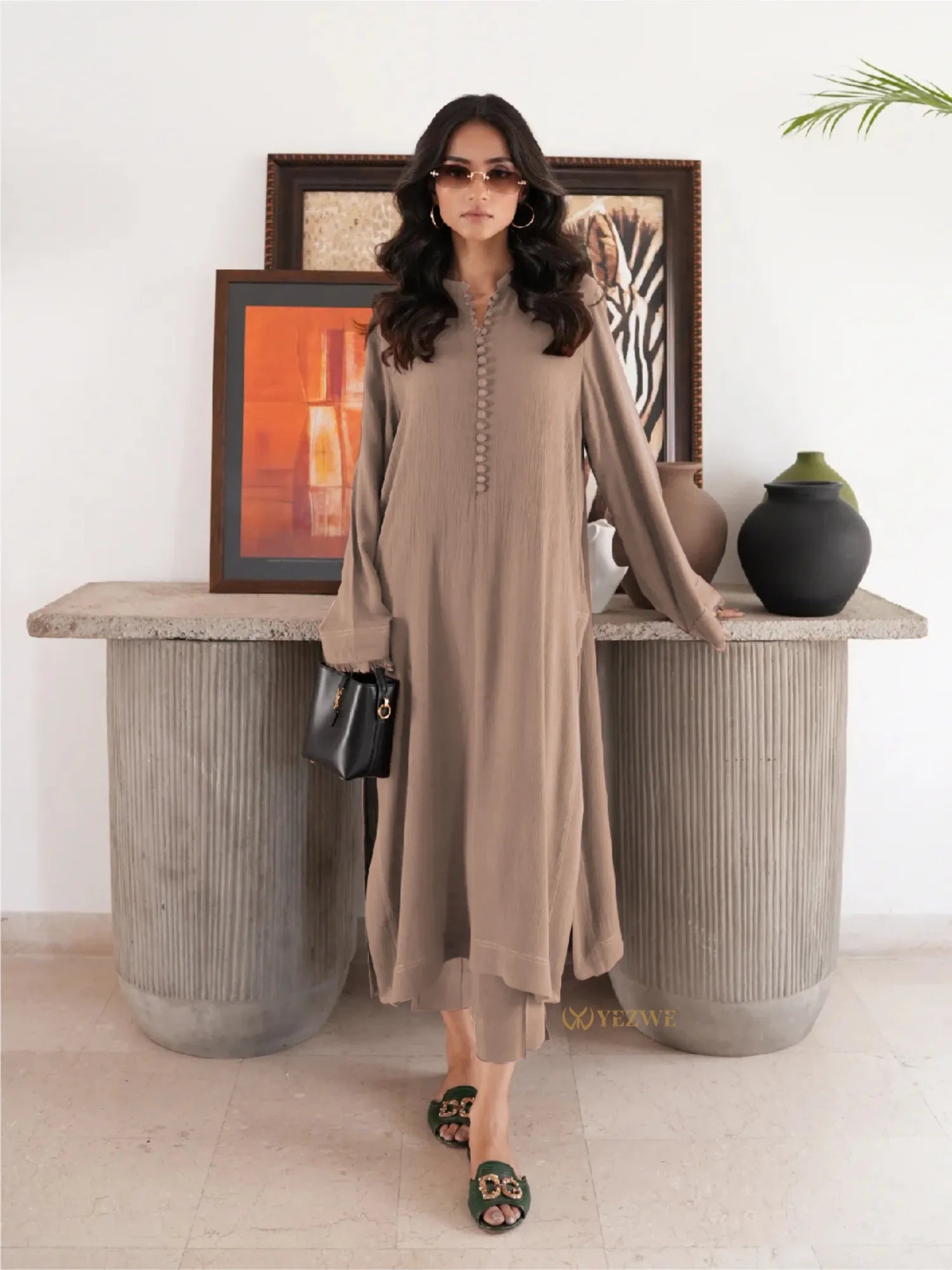 YEZWE brown Co-Ord Set with long sleeves and button details modeled with black handbag and sunglasses