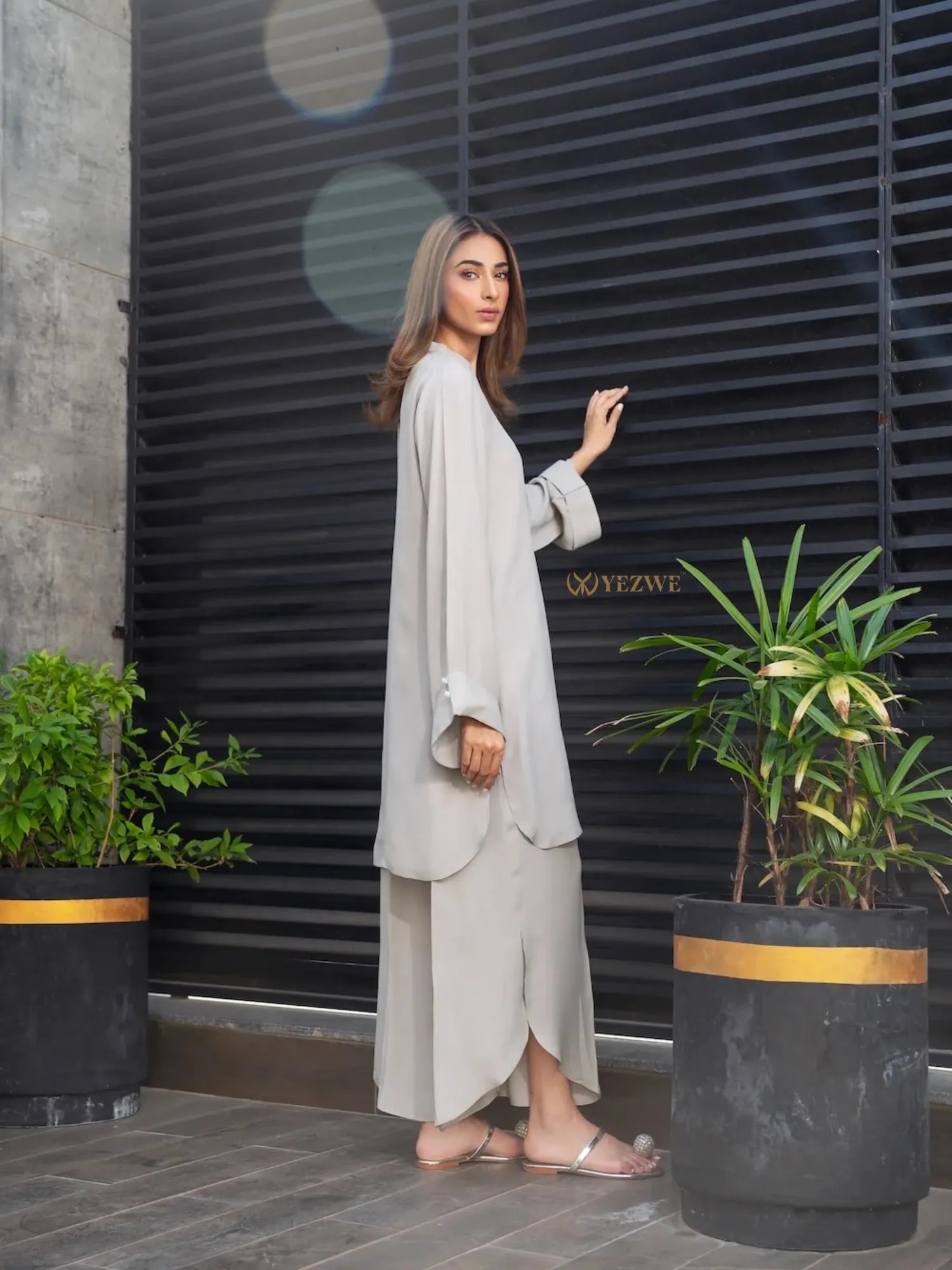 YEZWE stylish beige Co-Ord Set featuring a long top and matching wide-leg pants worn with sandals