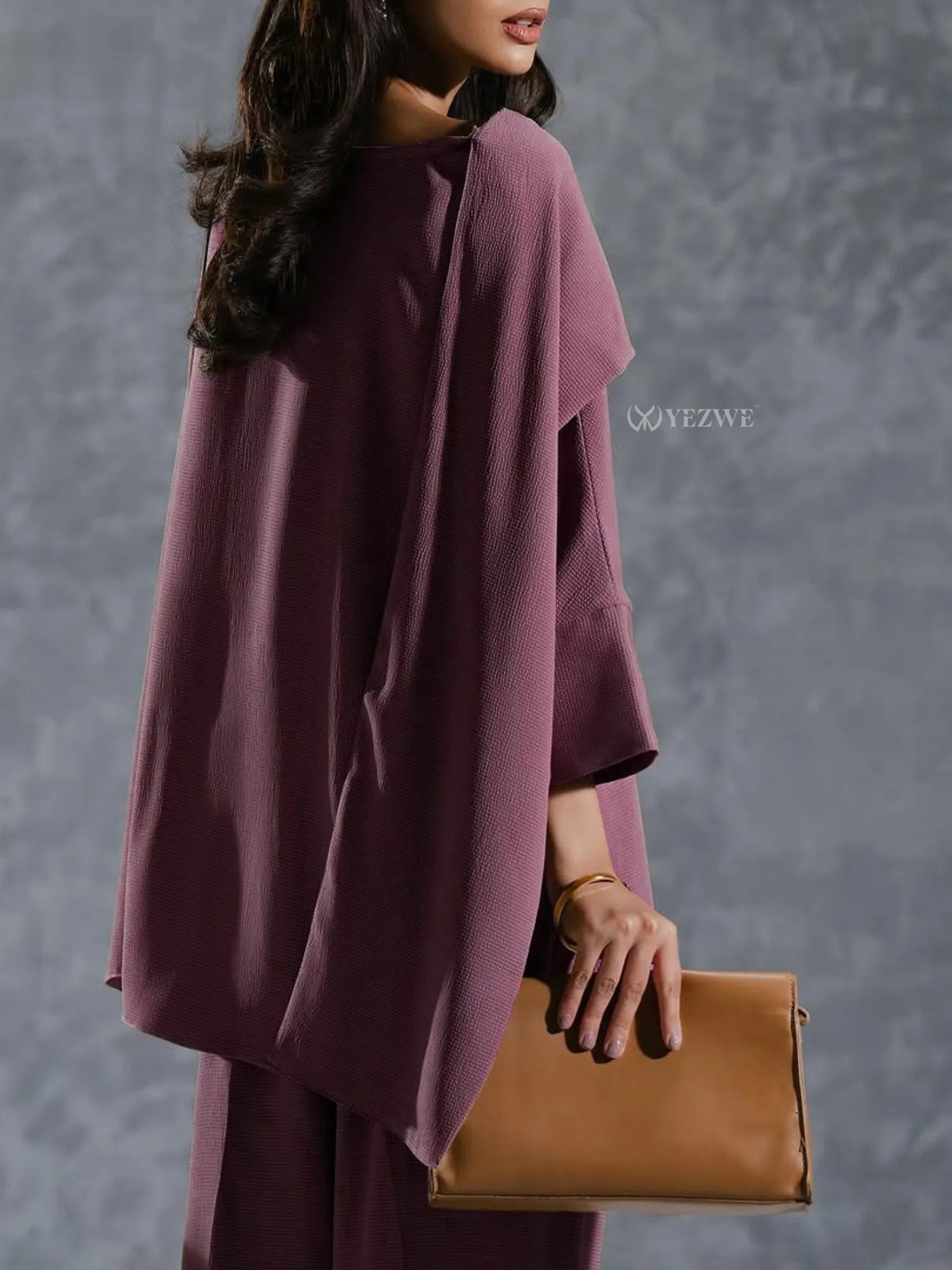 YEZWE mauve Co-Ord Set featuring a loose top and matching pants styled with a brown clutch bag