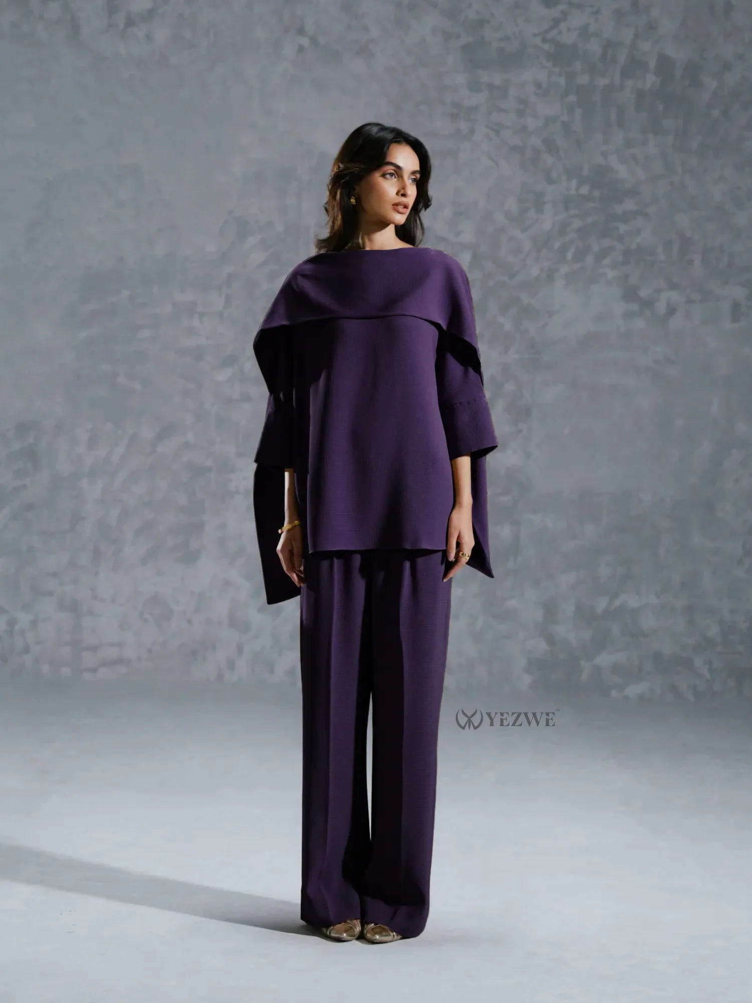 YEZWE purple Co-Ord Set with wide-leg pants and an asymmetrical top on female model