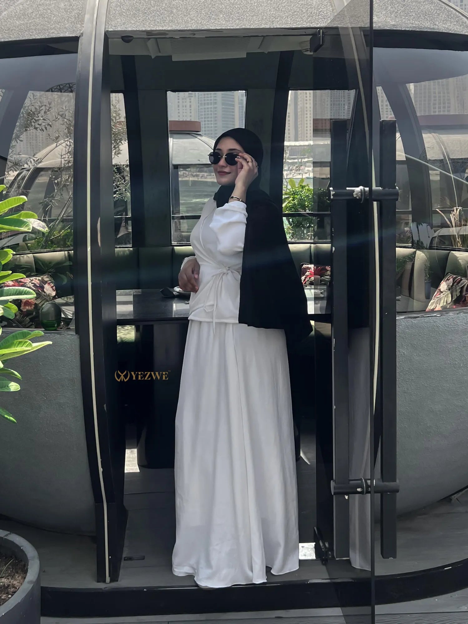 YEZWE white Co-Ord set with long skirt and fitted top worn with black hijab and sunglasses