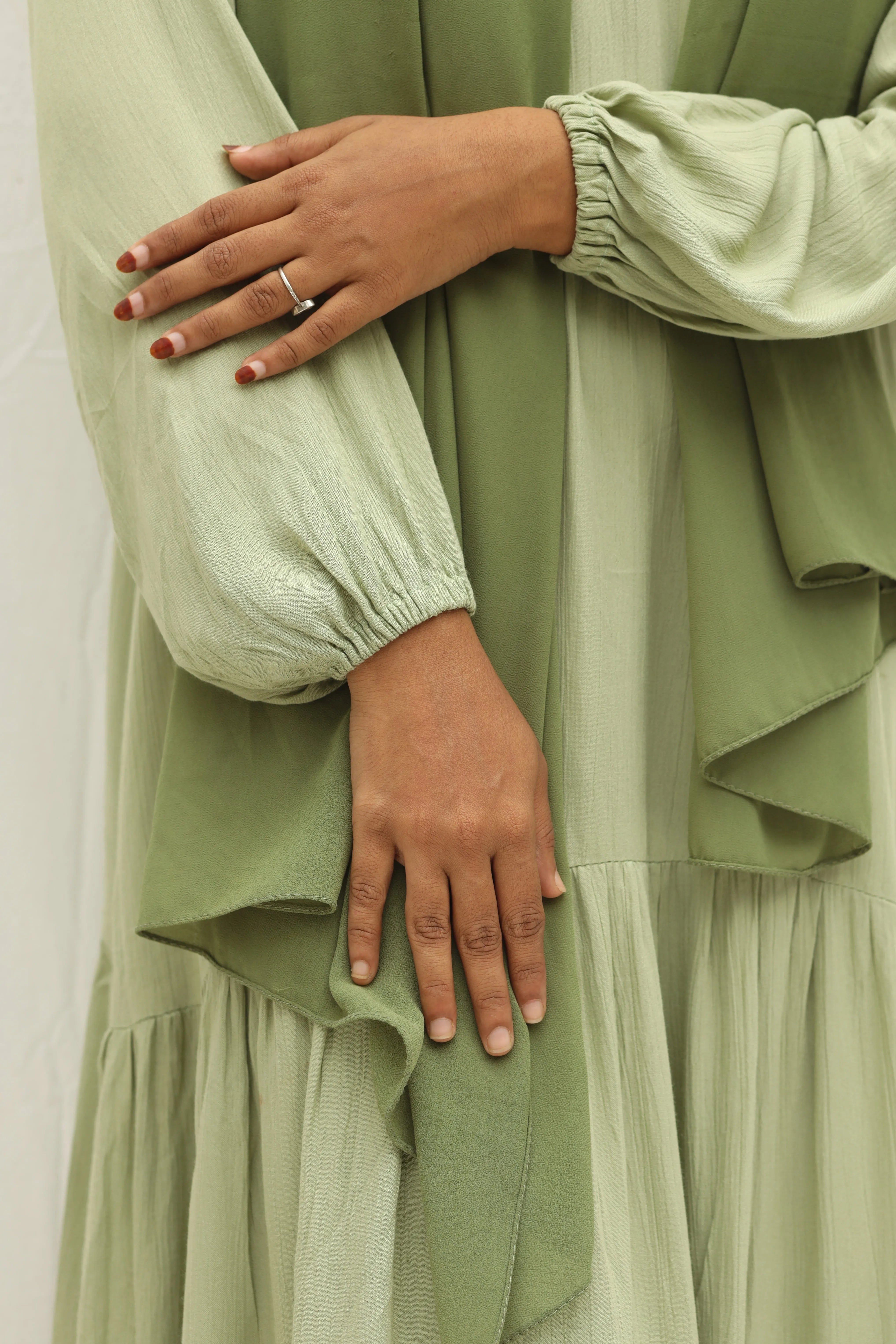 Yezwe custom modest dresses India featuring a soft green maxi dress with balloon sleeves and layered design