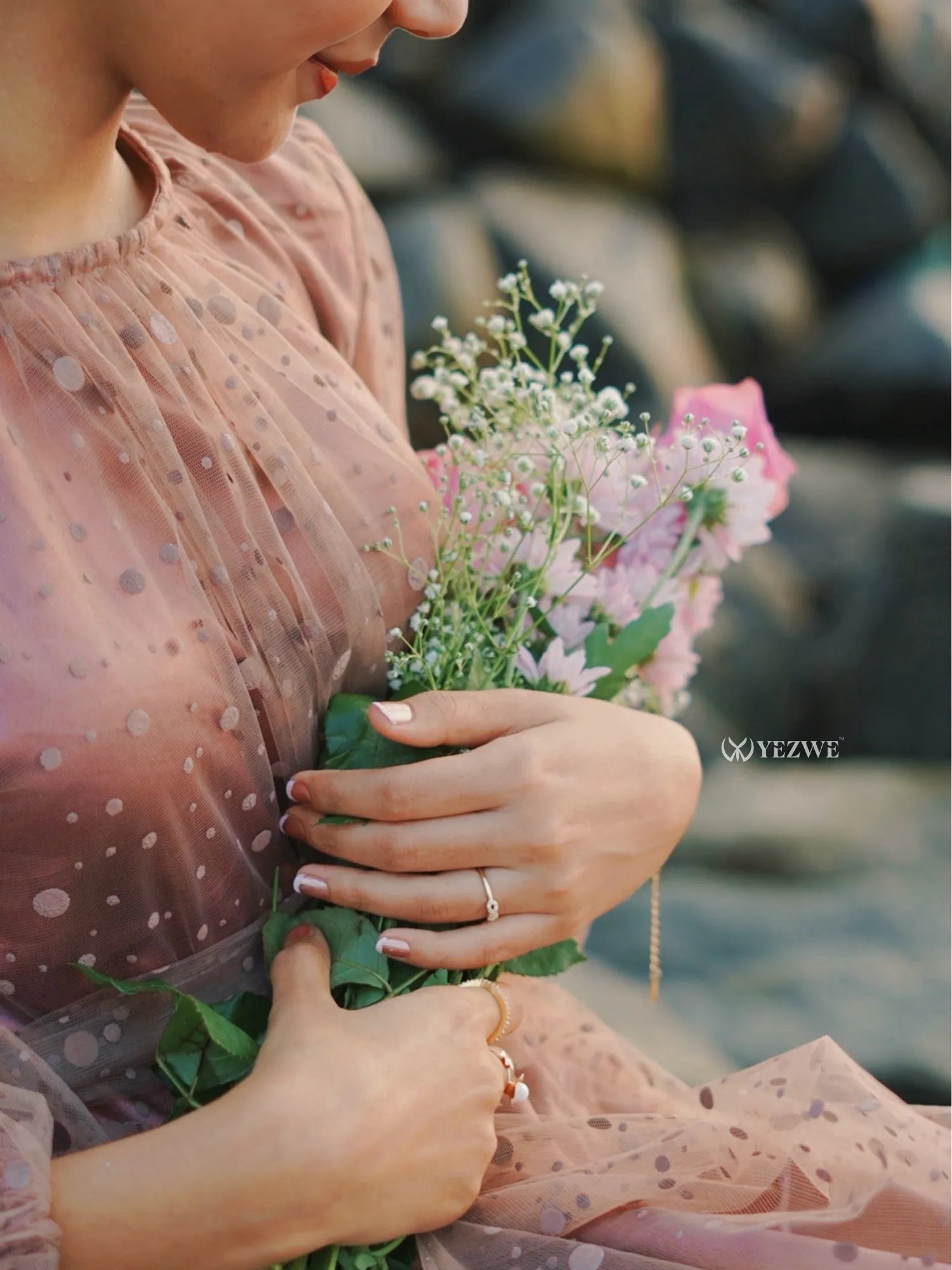 Dusty rose modest gown with a flowy design, perfect for special occasions, paired with fresh flowers