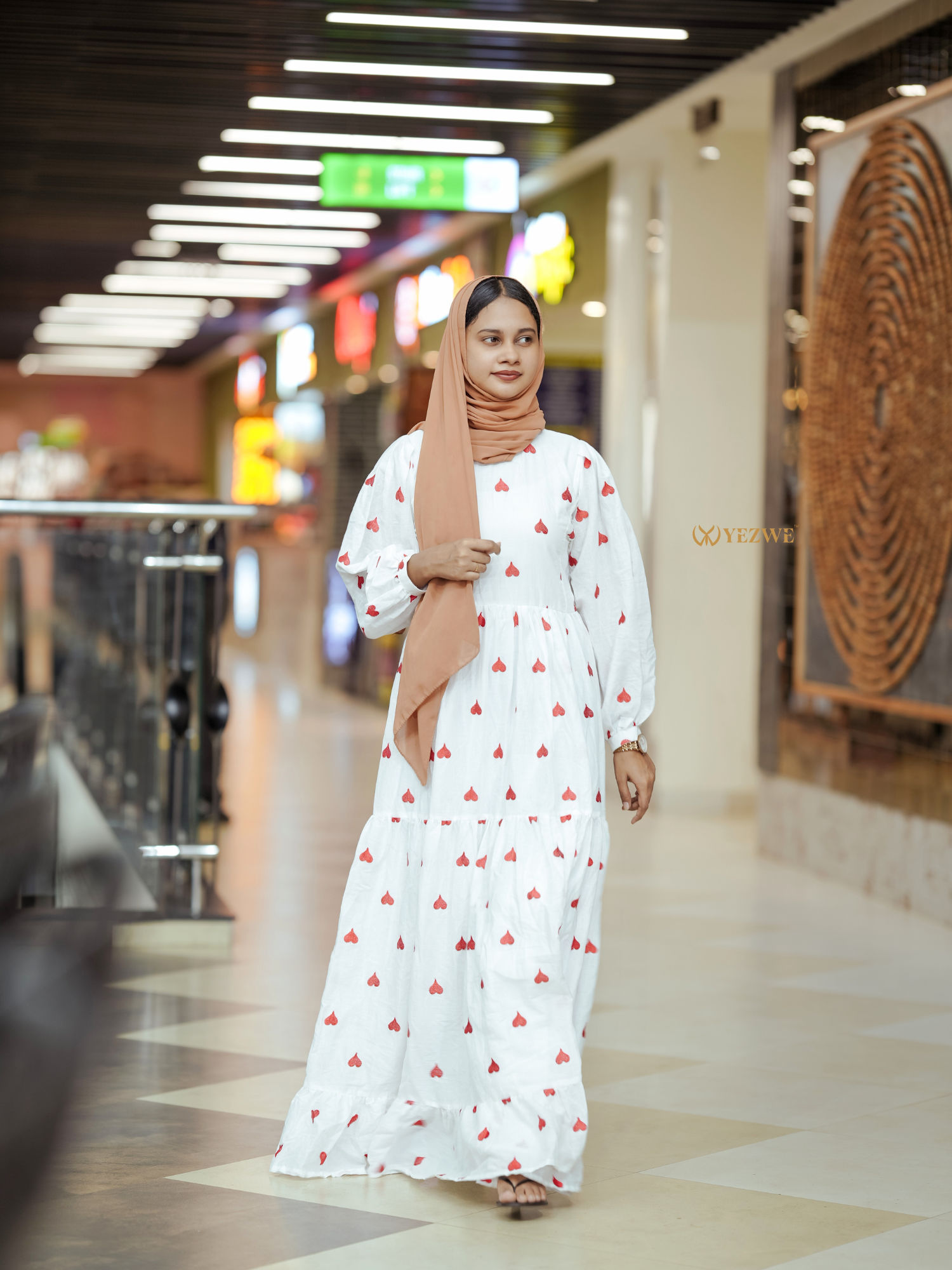 Elegant Yezwe embroidered kora fabric dress featuring a floral design and long sleeves