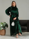 Yezwe emerald green modest maxi dress with long puff sleeves and belted waist on model