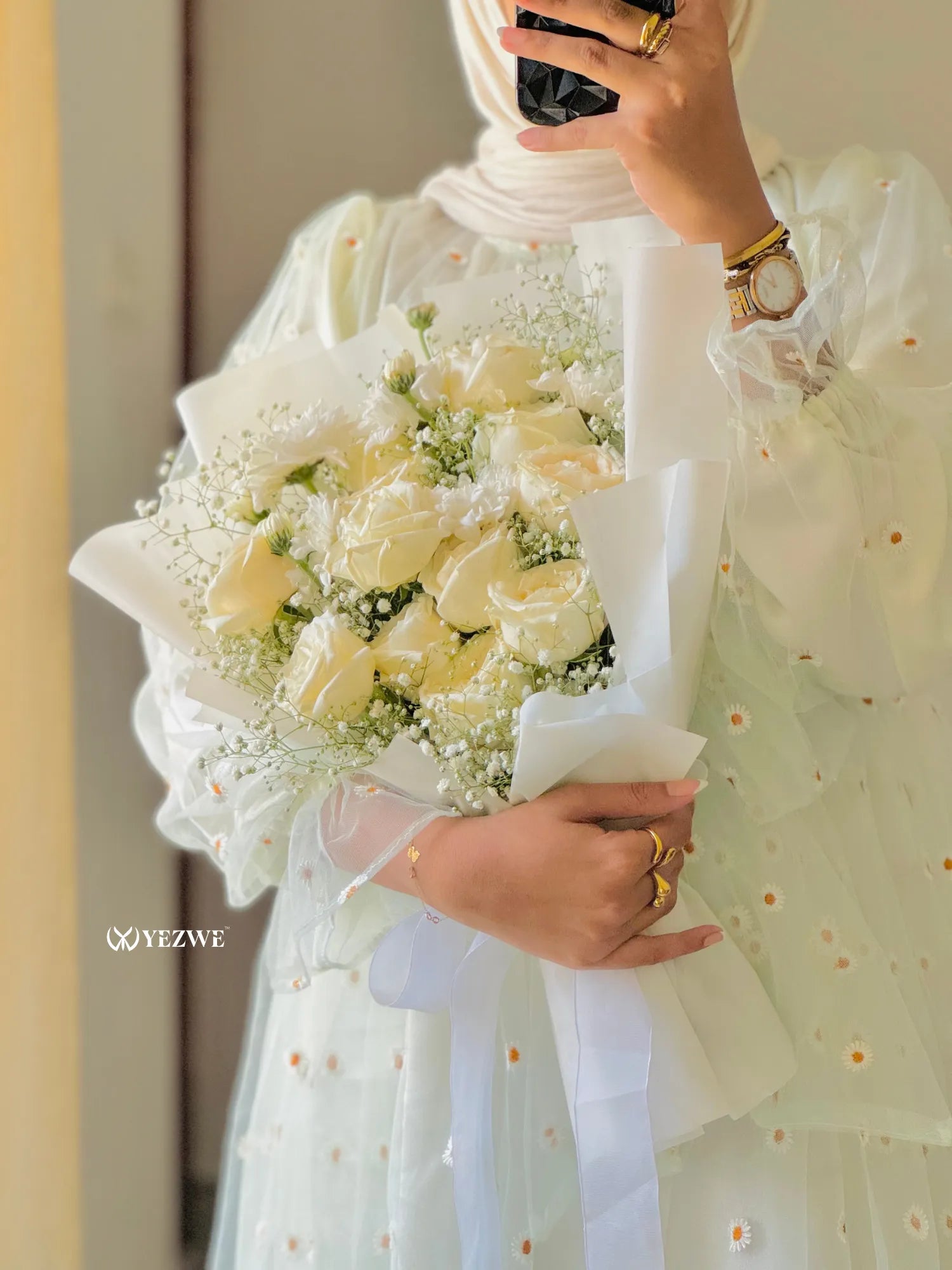 Yezwe floral embroidery gown styled with a bouquet of white roses for an elegant look