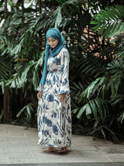 Yezwe Floral V-Neck Satin Dress with Flowing Sleeves Against a Lush Green Background