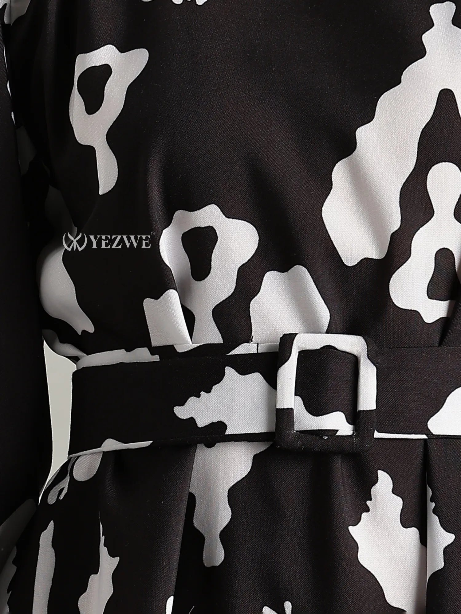 Close-up of YEZWE Full-Length Black Maxi Dress for Junior Girls with black and white abstract pattern and belt detail