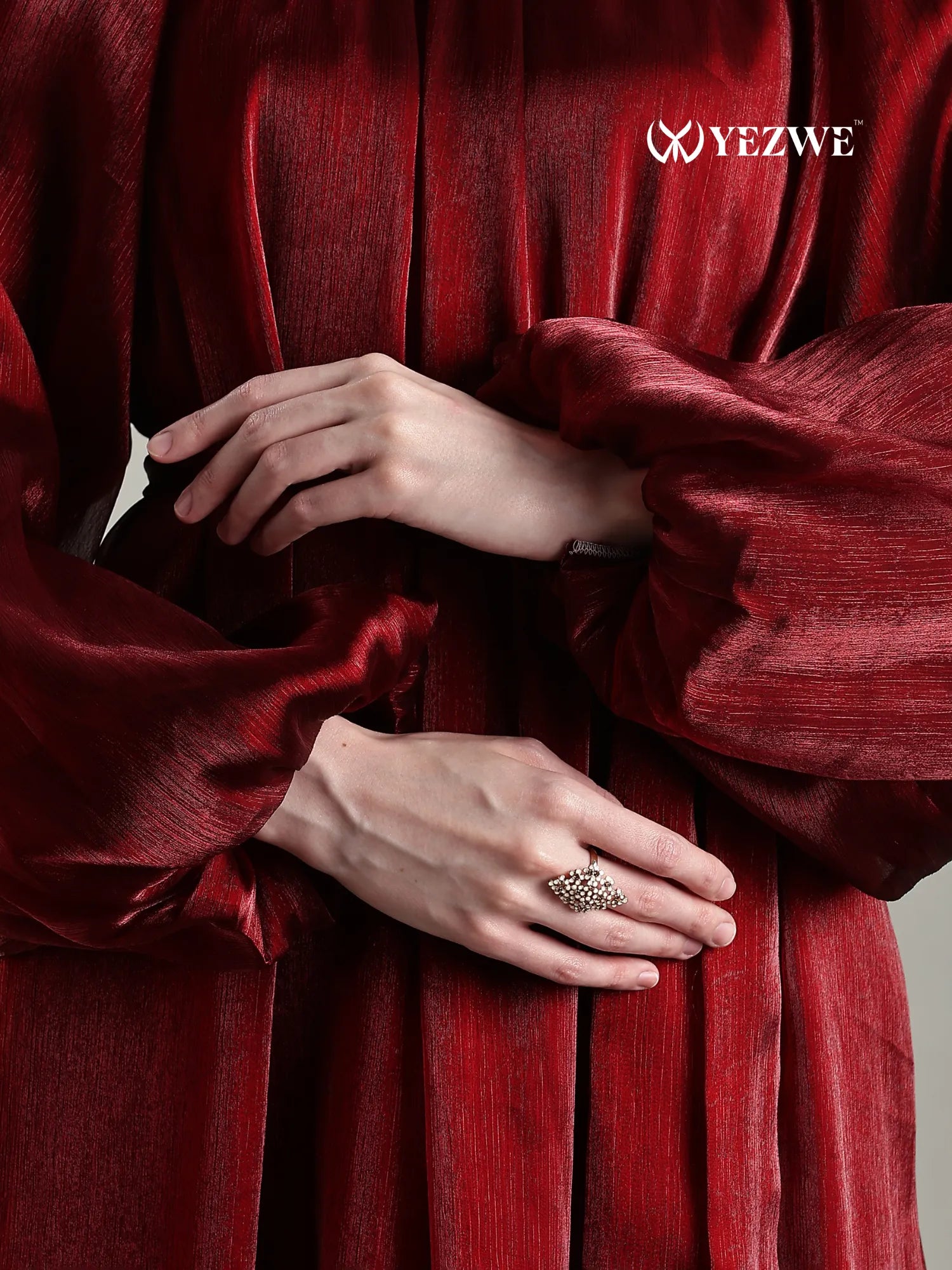 Close-up of Yezwe Full length jimicho Satin Flaired Maxi Dress in deep red with textured fabric and billowy sleeves