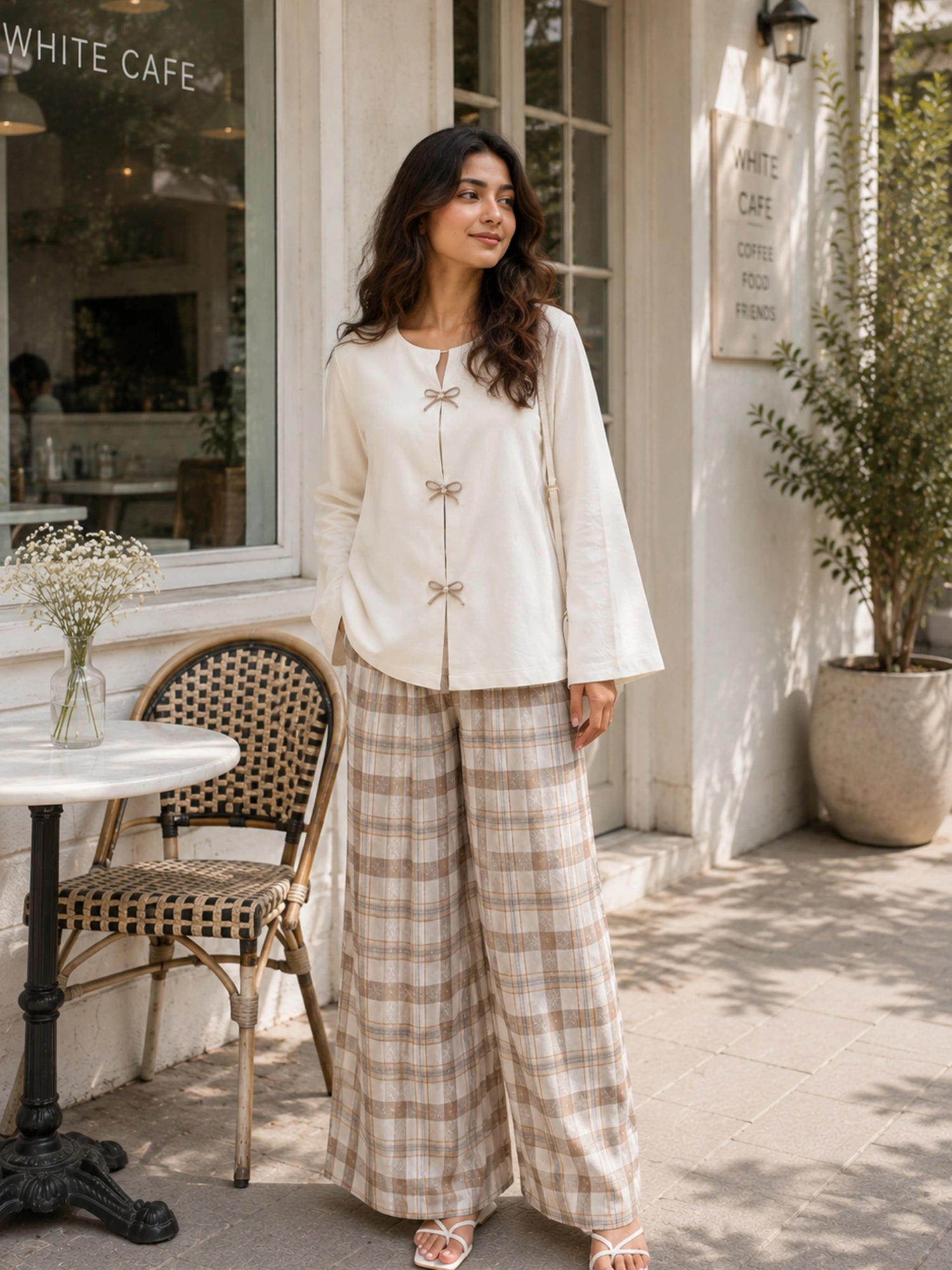 YEZWE Ivory Bow Cey Top And Plaid Modest Co-Ord Set For Women in a stylish outdoor café setting