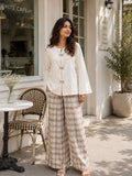 YEZWE Ivory Bow Cey Top And Plaid Modest Co-Ord Set For Women in a stylish outdoor café setting