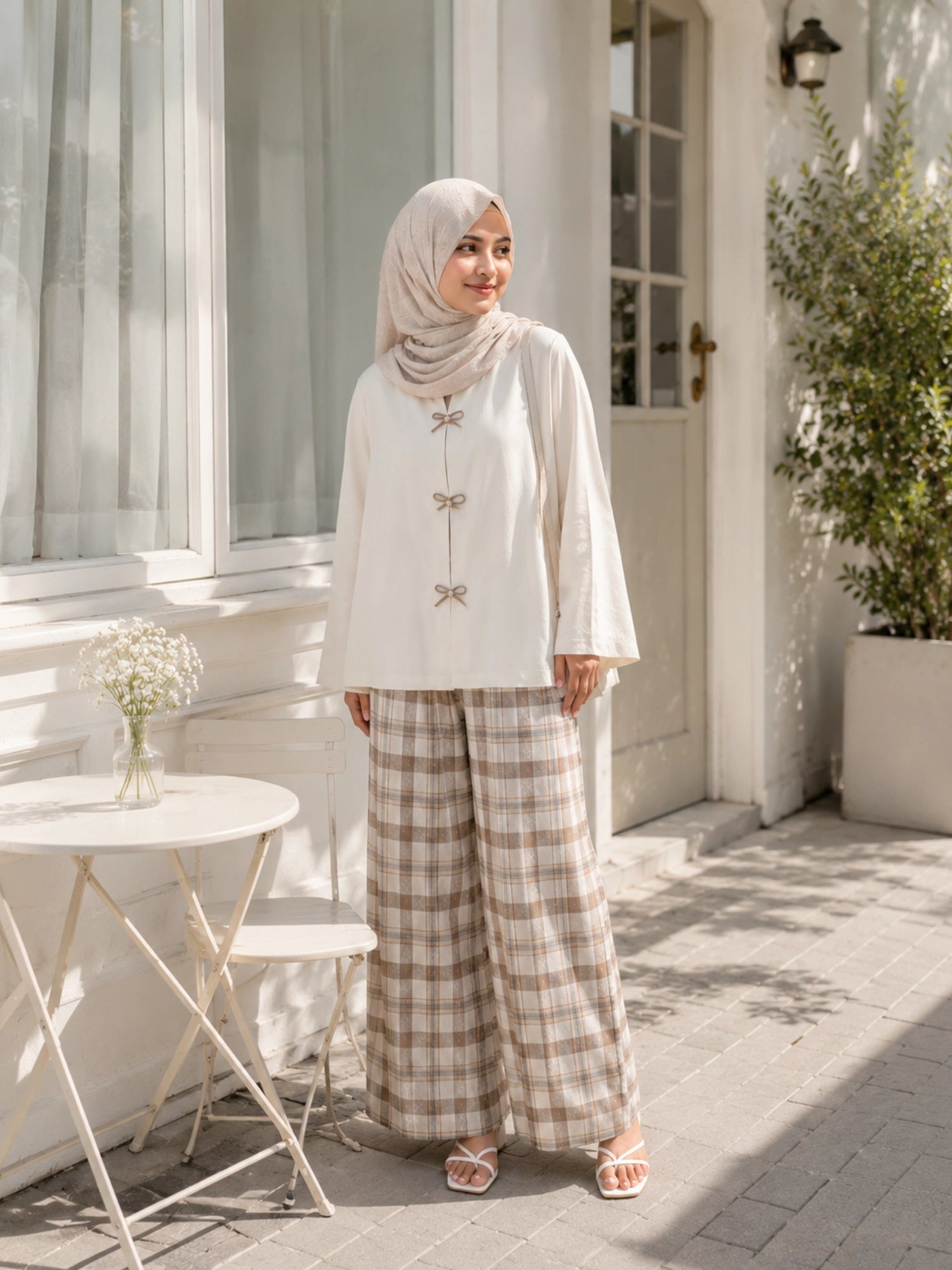 YEZWE Ivory Bow Cey Top And Plaid Modest Co-Ord Set For Women shown in outdoor setting