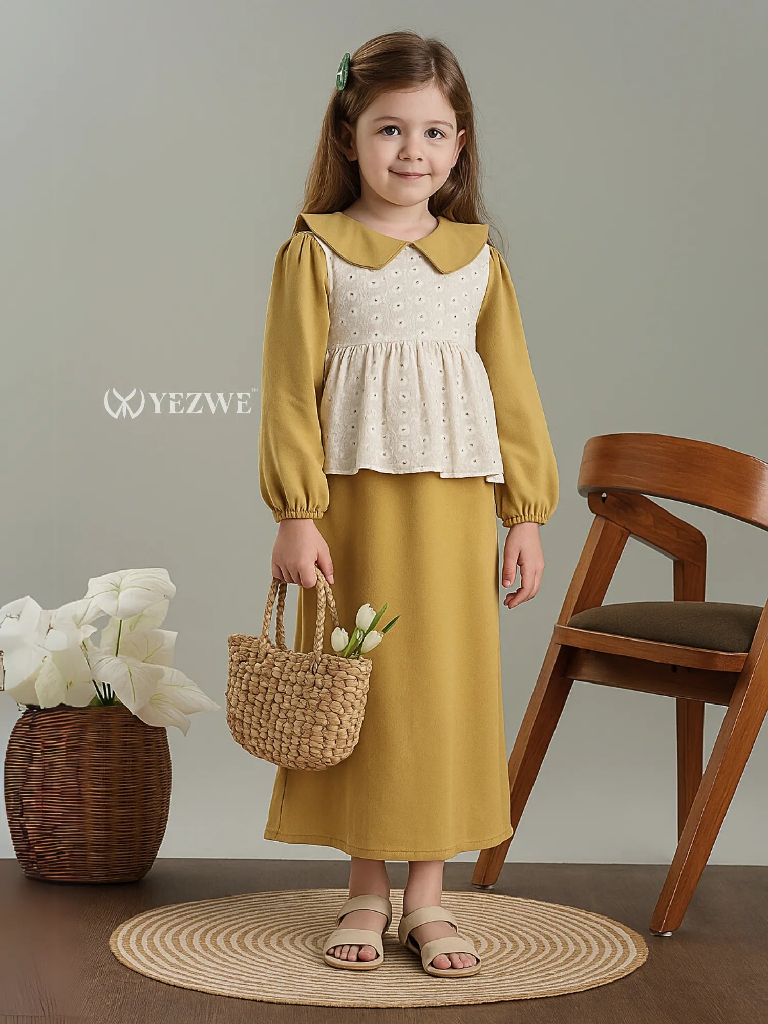 Junior Girls Maxi Dress with Hakoba Shrug in mustard and cream by Yezwe, worn by a young girl holding a woven basket