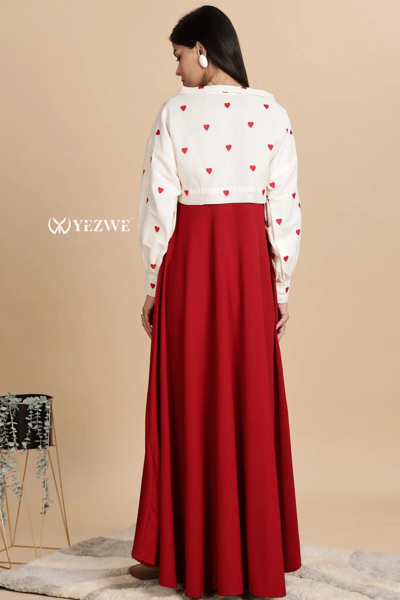 Stylish knitted red maxi dress with shrug featuring a white top with hearts for a chic look