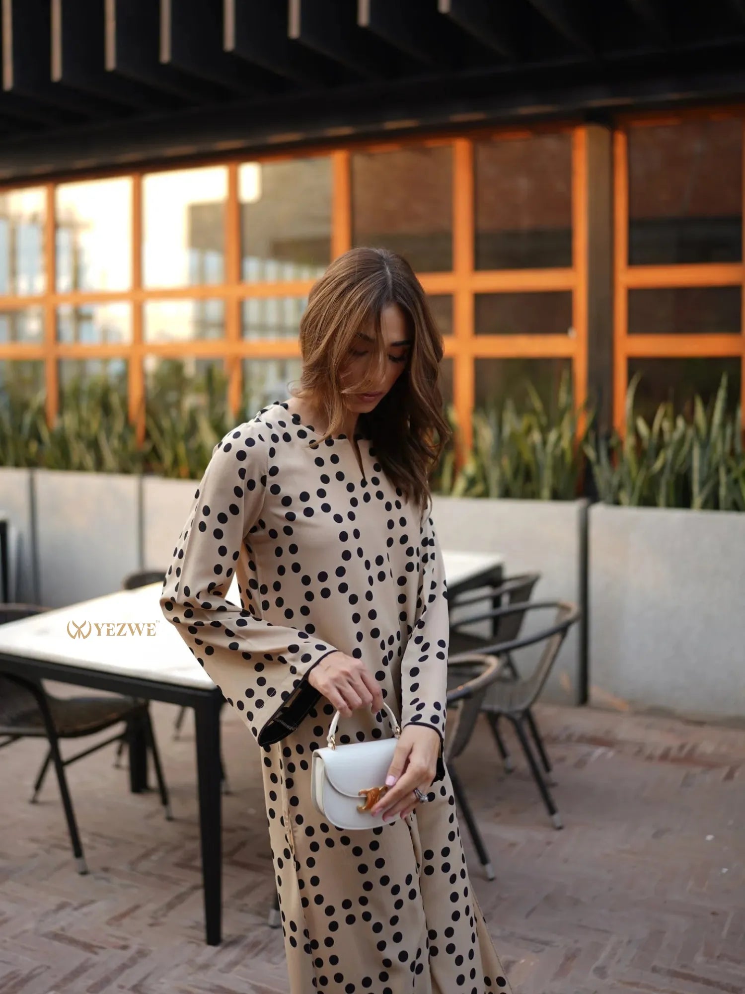 YEZWE beige polka dot long tunic with pant co-ord set worn by woman holding white purse