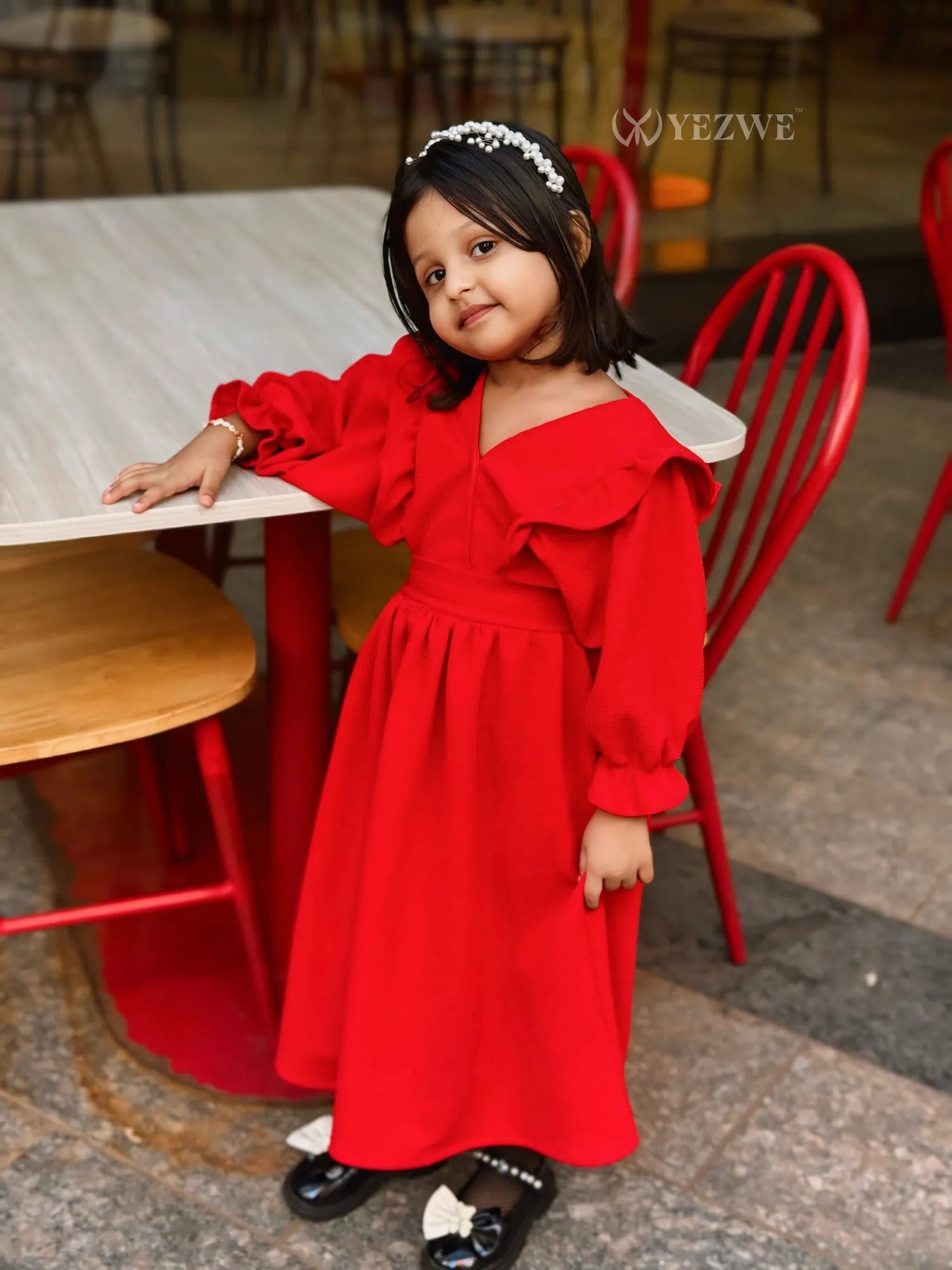 Junior girl wearing a red YEZWE maxi dress for junior girls with puffed sleeves and a ruffled collar