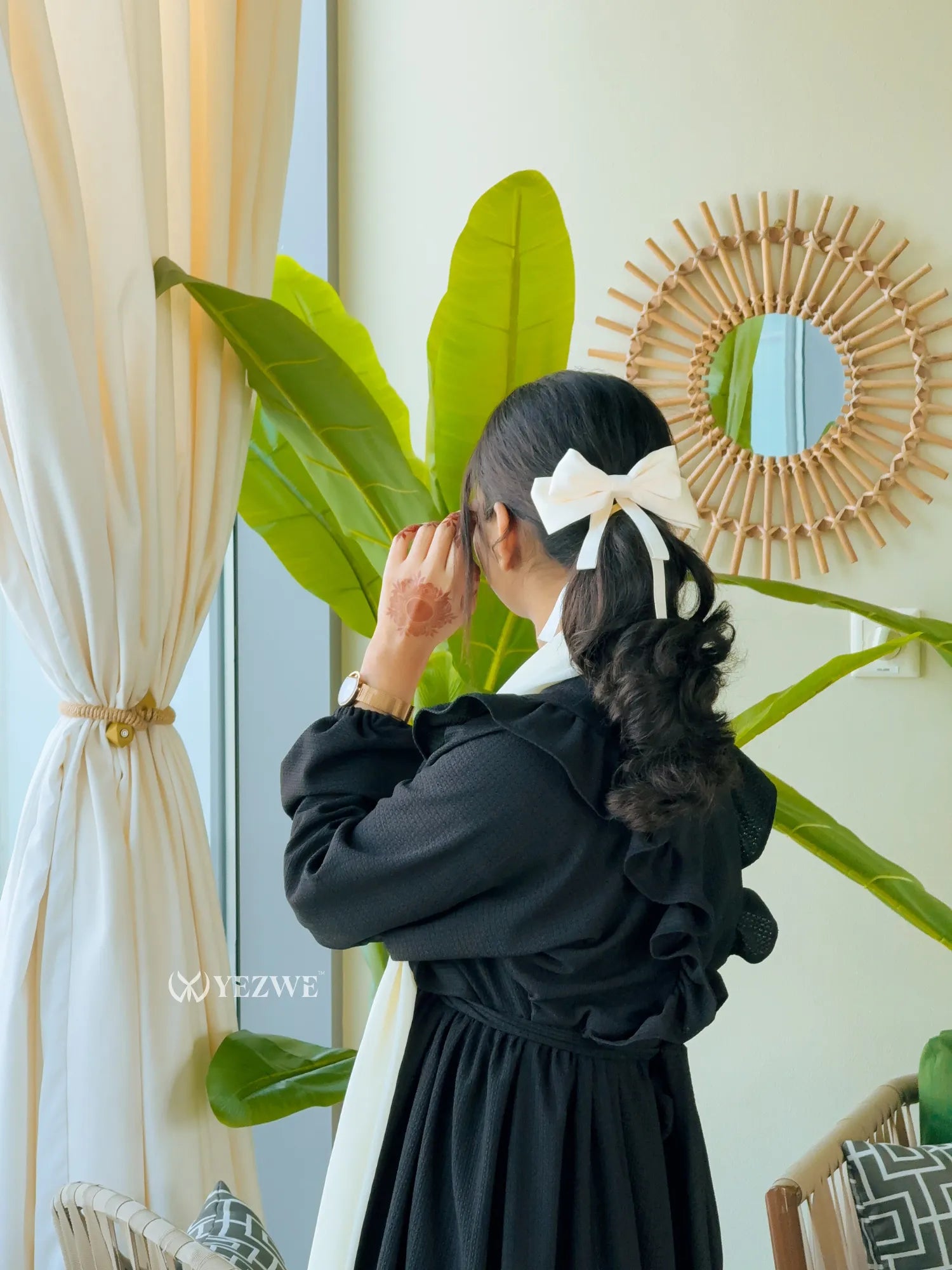 Yezwe modest black maxi dress with ruffle details, styled for a chic and elegant look