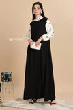 Modest black pinafore dress by YEZWE styled with a white blouse and clutch for a chic look