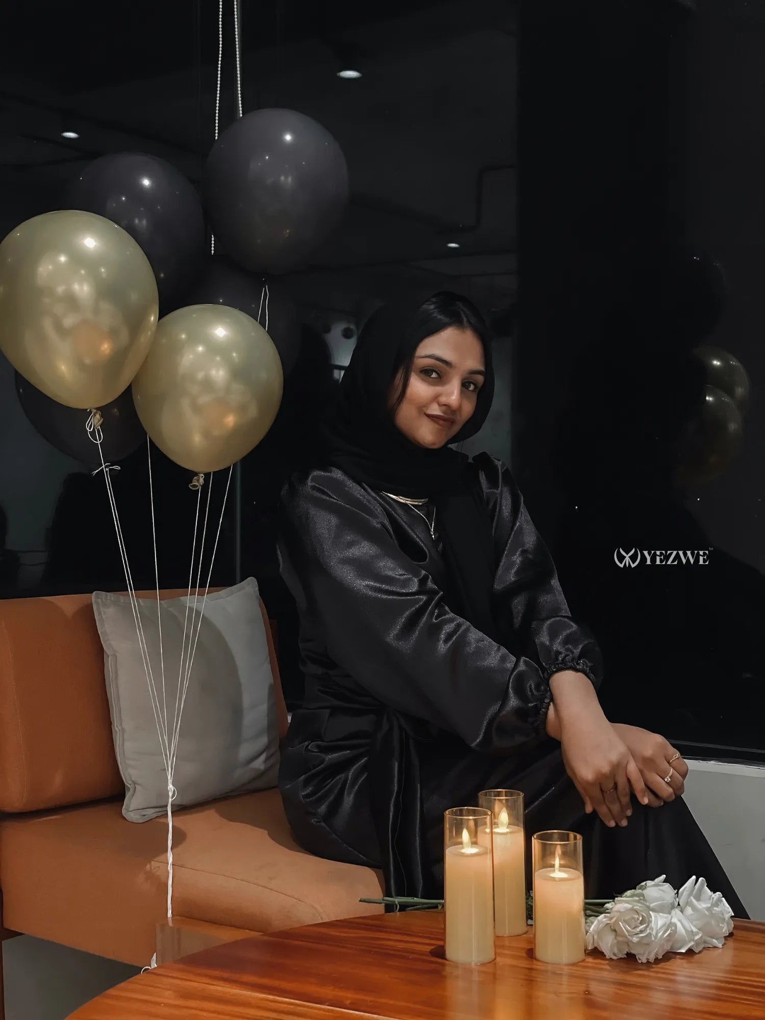 Modest black satin maxi dress from Yezwe styled with balloons and candles for an elegant look