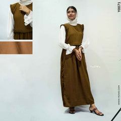 Modest brown dungaree outfit layered over a white blouse with ruffled details