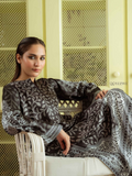 YEZWE Modest Co-Ord Set in grey and black paisley print long sleeve top and matching skirt model on wicker chair